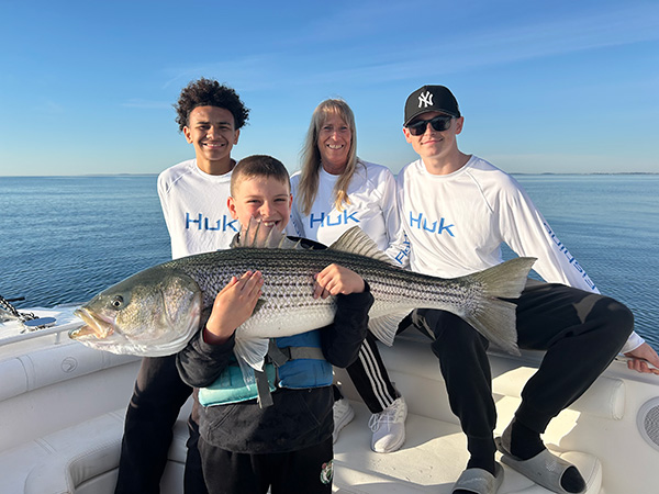 Youth Catch of the Week winner Caleb Brassard of Dunbarton, NH with his striped bass