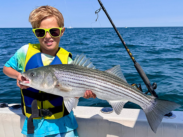 Youth Catch of the Week winner Roman Nussdorfer of Brewster, MA with his striped bass