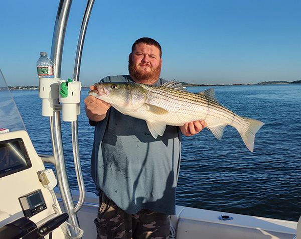 Week 20 Boat winner Michael Camerano of Somerville, MA with his striped bass